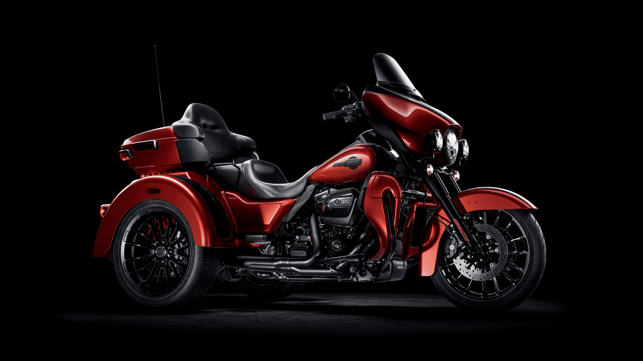Side view of a red 2025 Harley-Davidson® Tri Glide® Ultra three-wheeled motorcycle.